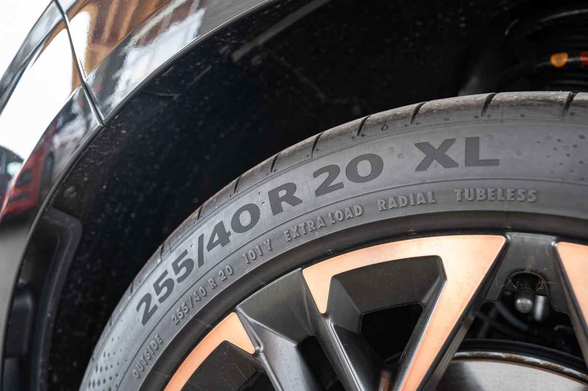 Detail shot of a new car tyre sidewall showing the 255 40 R20 XL size marking